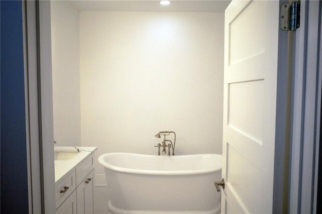 bathroom featuring a washtub and vanity