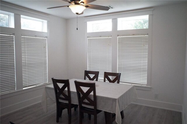 dining area featuring ceiling fan and dark wood-type flooring