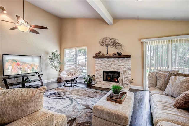 living room featuring wood-type flooring, vaulted ceiling with beams, ceiling fan, and a fireplace