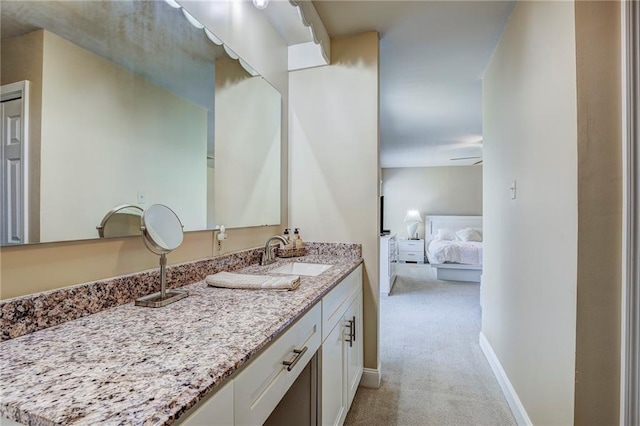 213 Surrey Dr, La Place, LA 70068 - bathroom with vanity, baseboards, and ensuite bathroom