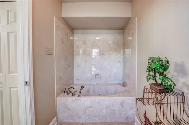 bathroom featuring a relaxing tiled tub