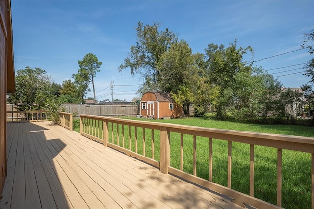 wooden deck featuring a yard and a storage unit