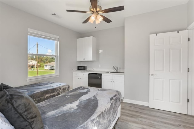 bedroom with light hardwood / wood-style floors, ceiling fan, and sink