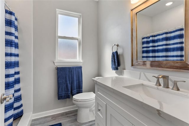 bathroom with vanity, toilet, a shower with shower curtain, and hardwood / wood-style flooring