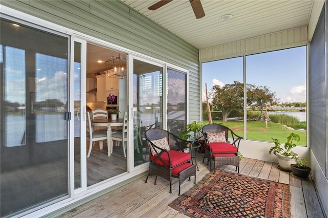 sunroom with ceiling fan with notable chandelier and plenty of natural light