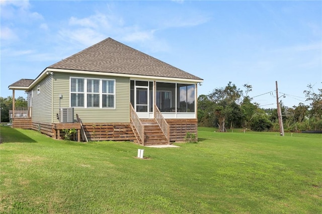 rear view of property with a sunroom and a yard