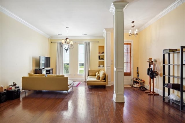 living room featuring crown molding, ornate columns, a chandelier, and dark hardwood / wood-style flooring