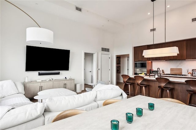 living room featuring a towering ceiling