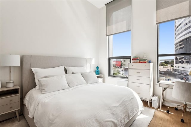 bedroom featuring light hardwood / wood-style floors and multiple windows