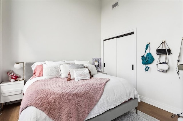 bedroom with a closet and hardwood / wood-style flooring