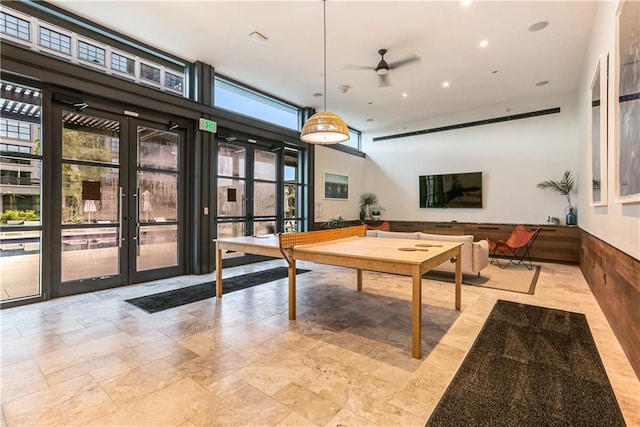 rec room featuring french doors, ceiling fan, and a wealth of natural light