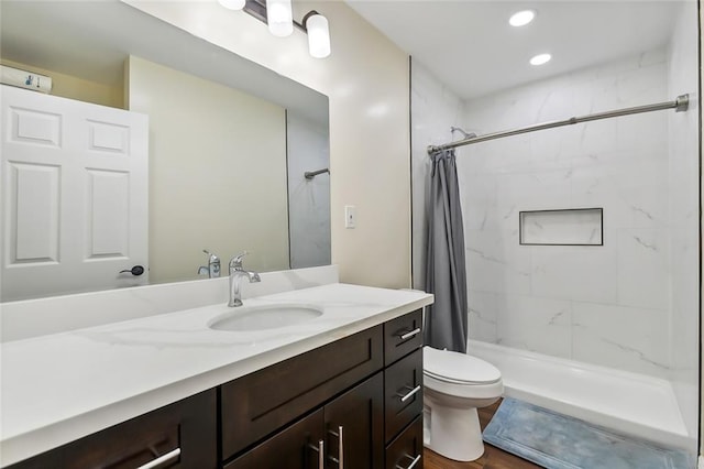 bathroom with vanity, toilet, a shower with shower curtain, and hardwood / wood-style flooring