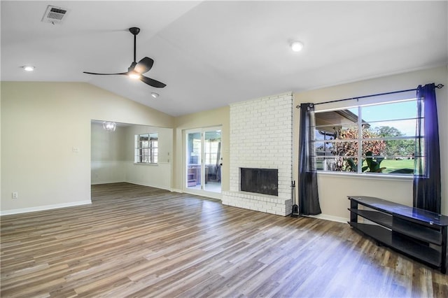 unfurnished living room featuring hardwood / wood-style flooring, plenty of natural light, ceiling fan, and vaulted ceiling