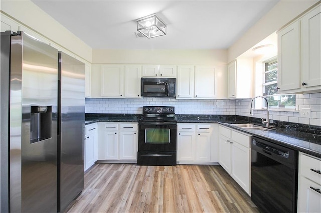 kitchen with black appliances, light hardwood / wood-style floors, white cabinets, and tasteful backsplash