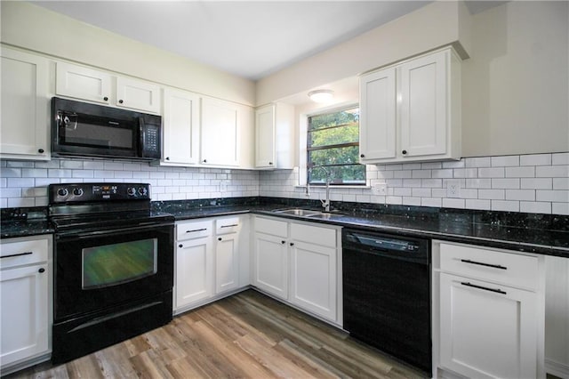 kitchen featuring black appliances, sink, hardwood / wood-style flooring, decorative backsplash, and white cabinetry