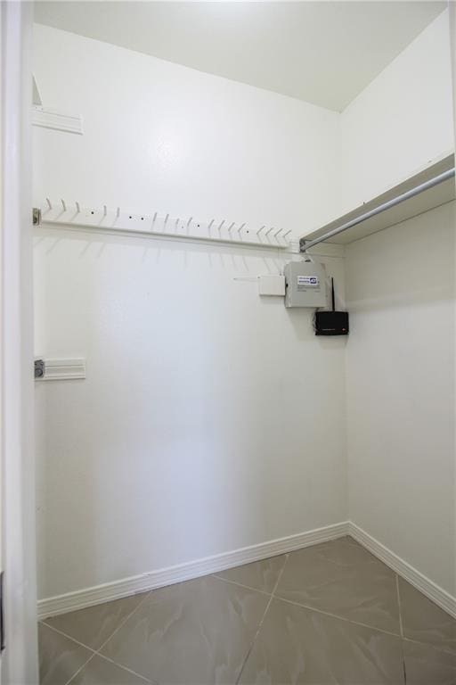 walk in closet with tile patterned floors