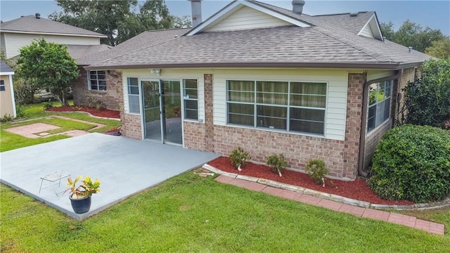 back of property featuring a patio area and a yard