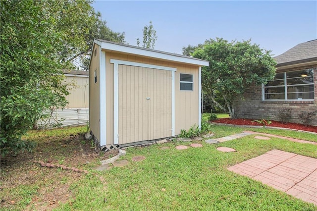 view of outbuilding with a yard