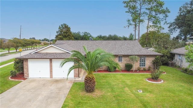 single story home with central AC unit, a garage, and a front yard