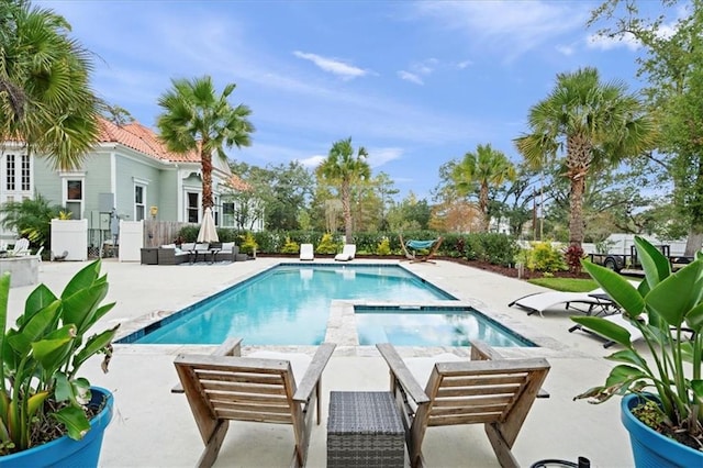 view of pool featuring an in ground hot tub and a patio area