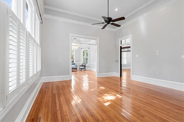 unfurnished room featuring light hardwood / wood-style flooring, ceiling fan, a healthy amount of sunlight, and crown molding