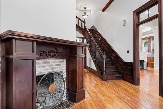 interior space with ornamental molding, hardwood / wood-style flooring, and a fireplace