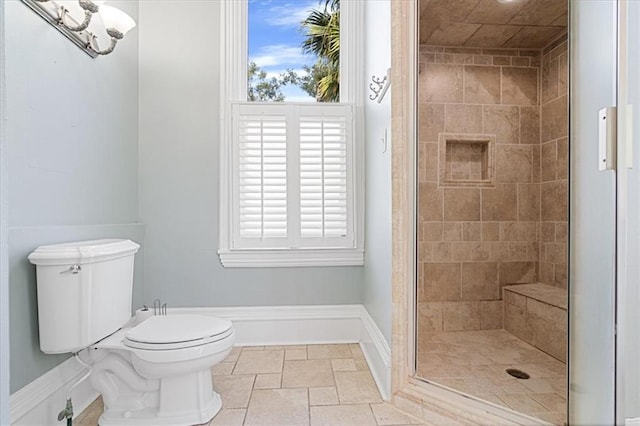 bathroom featuring toilet and tiled shower