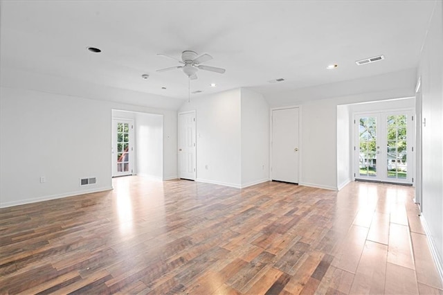 empty room with ceiling fan, hardwood / wood-style flooring, and french doors