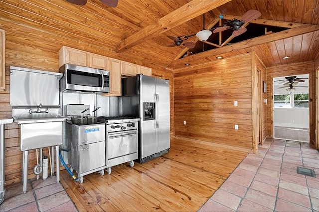 kitchen with ceiling fan, stainless steel appliances, lofted ceiling with beams, and wooden ceiling