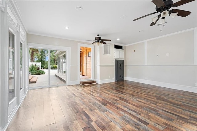 unfurnished living room with ceiling fan, hardwood / wood-style flooring, and crown molding