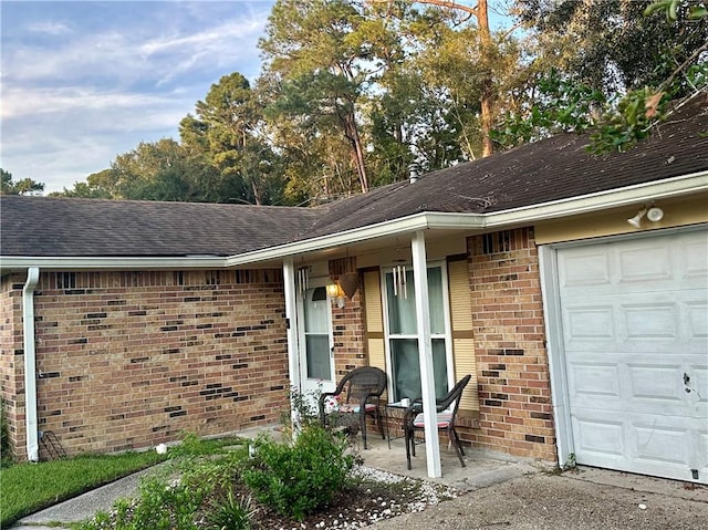 doorway to property with a garage