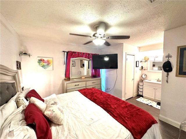 bathroom featuring a textured ceiling, walk in shower, tile patterned floors, vanity, and toilet