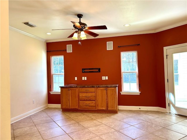 kitchen with ceiling fan, light tile patterned floors, and crown molding