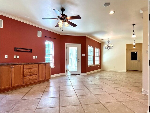 interior space featuring ceiling fan with notable chandelier and crown molding