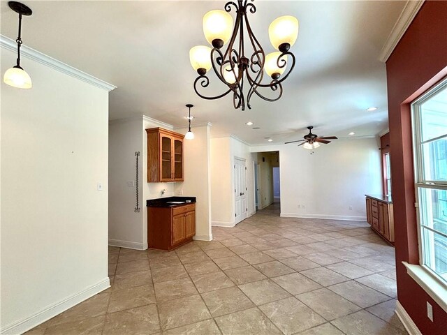 kitchen featuring ceiling fan with notable chandelier, decorative light fixtures, and crown molding