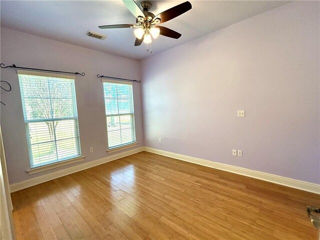 empty room with light hardwood / wood-style floors and ceiling fan