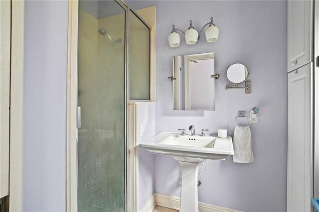 bathroom with a shower with shower door