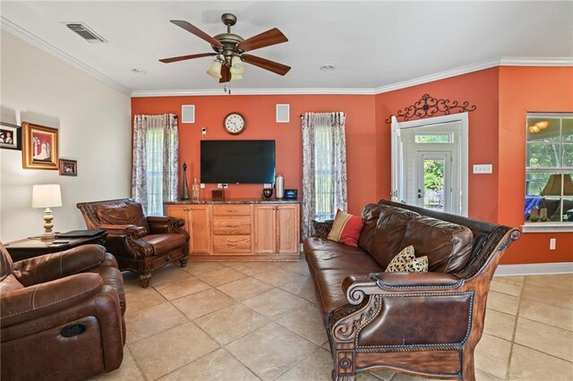 tiled living room with ceiling fan and ornamental molding