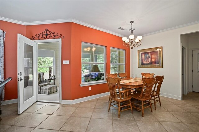 dining space with light tile patterned floors, a notable chandelier, and ornamental molding