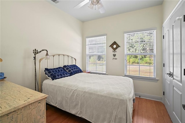 bedroom with ceiling fan and dark hardwood / wood-style floors