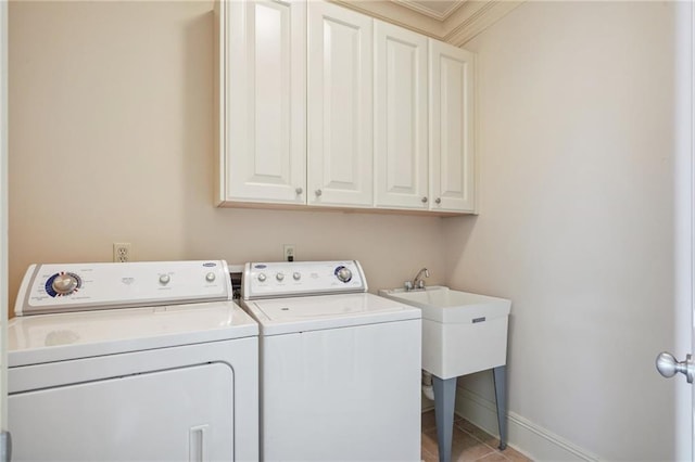 laundry room with washer and clothes dryer, cabinets, crown molding, and light tile patterned floors