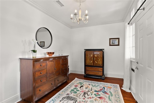 bedroom with ornamental molding, a chandelier, and dark hardwood / wood-style flooring