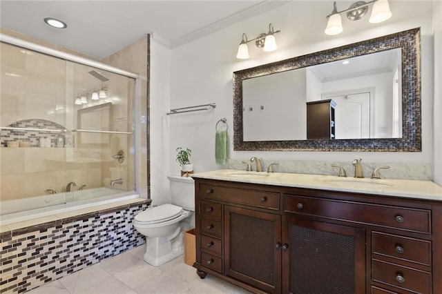 full bathroom featuring ornamental molding, enclosed tub / shower combo, vanity, and toilet