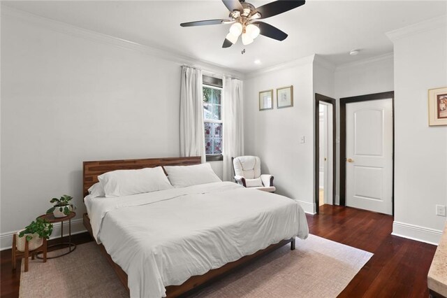 bedroom featuring ornamental molding, ceiling fan, and dark wood-type flooring