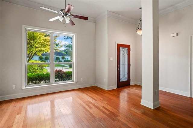 entrance foyer with ceiling fan, hardwood / wood-style flooring, and crown molding