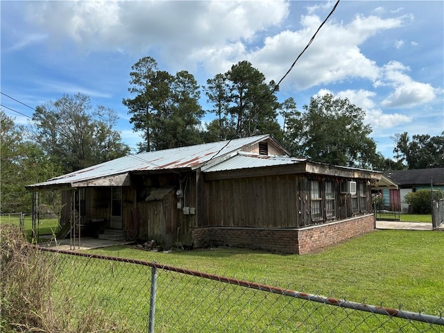 exterior space featuring a yard and a sunroom