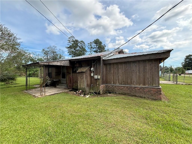 back of property with a patio and a yard