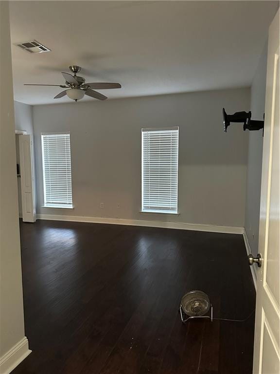 spare room with hardwood / wood-style flooring and ceiling fan