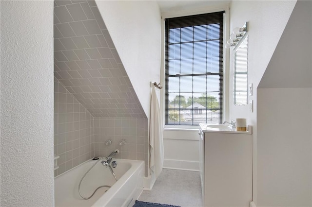 bathroom featuring vanity and a tub to relax in