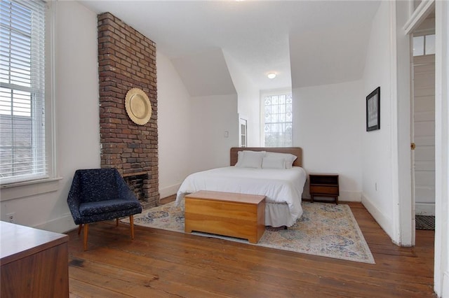 bedroom with wood-type flooring and lofted ceiling